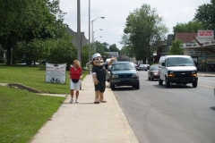 Johnny and Nancy wave to passing traffic